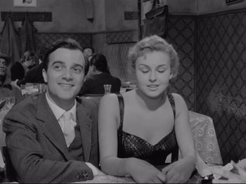 Movie still from “The Girlfriends” (1955), directed by Michelangelo Antonioni – A man and a woman sitting next to each other; Medium shot, Low angle