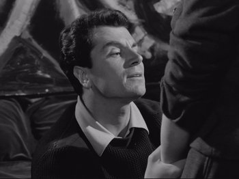 Movie still from “The Girlfriends” (1955), directed by Michelangelo Antonioni – A black - and - white photo of a man looking up; Close Up shot, Over the shoulder angle