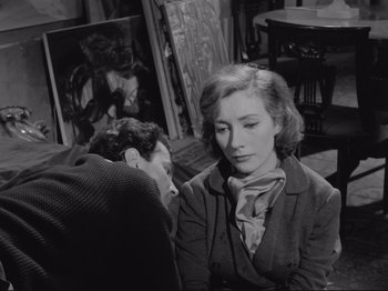 Movie still from “The Girlfriends” (1955), directed by Michelangelo Antonioni – A man and a woman sitting in a room together; Medium shot, High angle
