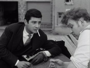 Movie still from “Le Beau Serge” (1958), directed by Claude Chabrol – A man and a woman sitting at a table; Medium shot, Over the shoulder angle