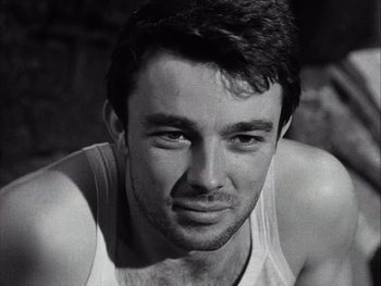 Movie still from “Le Beau Serge” (1958), directed by Claude Chabrol – Black and white photograph of a man in a tank top; Close Up shot, Low angle