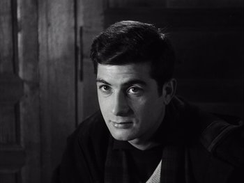 Movie still from “Le Beau Serge” (1958), directed by Claude Chabrol – Black and white photograph of a young man in a black shirt; Close Up shot, High angle