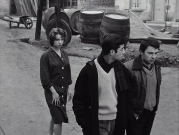 Movie still from “Le Beau Serge” (1958), directed by Claude Chabrol – A group of people standing next to each other on a street; Medium shot, High angle
