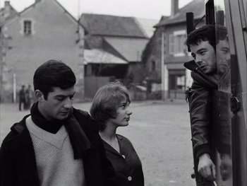 Movie still from “Le Beau Serge” (1958), directed by Claude Chabrol – A man and a woman standing next to each other on a street; Medium shot, Low angle