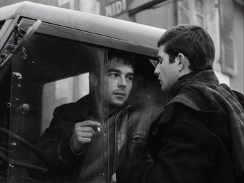 Movie still from “Le Beau Serge” (1958), directed by Claude Chabrol – Two men standing next to each other in front of a window; Close Up shot, Over the shoulder angle