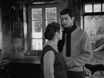 Movie still from “Le Beau Serge” (1958), directed by Claude Chabrol – A man and a woman standing next to each other in a room; Medium shot, Low angle