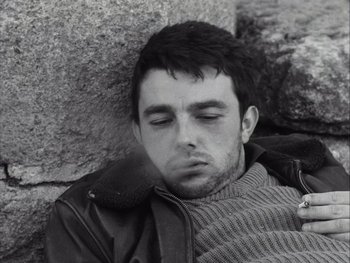 Movie still from “Le Beau Serge” (1958), directed by Claude Chabrol – Black and white photograph of a man sleeping on the ground; Close Up shot, Low angle