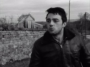 Movie still from “Le Beau Serge” (1958), directed by Claude Chabrol – Black and white photograph of a man in a leather jacket; Close Up shot, Over the shoulder angle