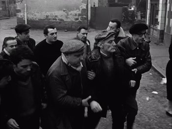Movie still from “Le Beau Serge” (1958), directed by Claude Chabrol – A black and white photo of a group of men; Medium shot, High angle