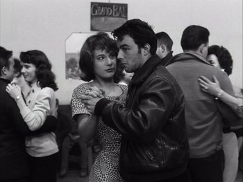 Movie still from “Le Beau Serge” (1958), directed by Claude Chabrol – A man and a woman are dancing in a room; Medium shot, Low angle
