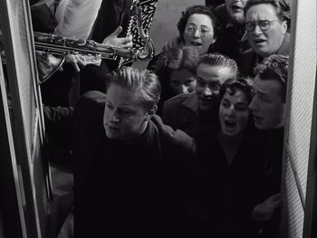 Movie still from “Le Beau Serge” (1958), directed by Claude Chabrol – A group of people standing next to each other; Medium shot, High angle
