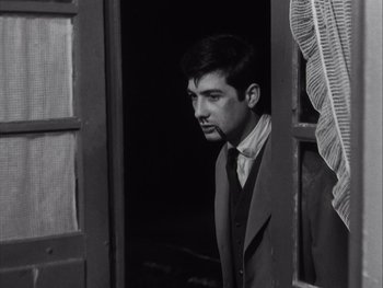 Movie still from “Le Beau Serge” (1958), directed by Claude Chabrol – Black and white photograph of a man in a doorway; Close Up shot, Low angle
