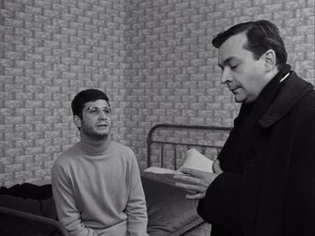 Movie still from “Le Beau Serge” (1958), directed by Claude Chabrol – Two men are talking in front of a bed; Medium shot, Over the shoulder angle