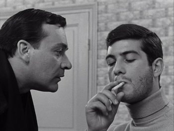 Movie still from “Le Beau Serge” (1958), directed by Claude Chabrol – Two men are looking at each other while one of them is brushing his teeth; Close Up shot, Low angle
