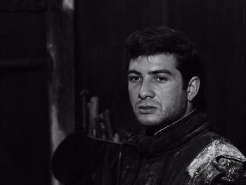 Movie still from “Le Beau Serge” (1958), directed by Claude Chabrol – Black and white photograph of a man in a jacket; Close Up shot, Low angle
