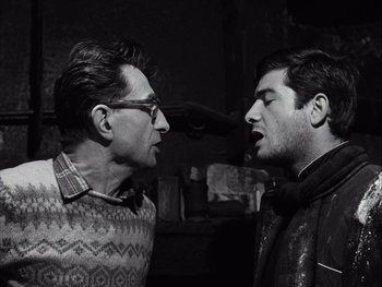 Movie still from “Le Beau Serge” (1958), directed by Claude Chabrol – Two men are facing each other in a dark room; Close Up shot, Low angle