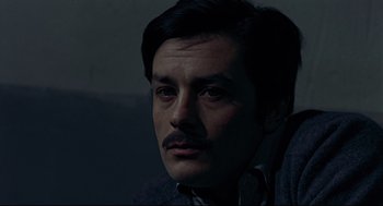 Movie still from “The Red Circle” (1970), directed by Jean-Pierre Melville – A person with a mustache; Close Up shot, High angle