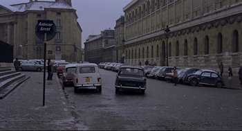 Movie still from “The Red Circle” (1970), directed by Jean-Pierre Melville – Cars parked on the side of the road in the rain; Extreme Wide shot, High angle