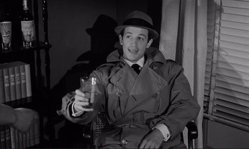 Movie still from “Le Doulos” (1962), directed by Jean-Pierre Melville – A black and white photo of a man holding a glass of beer; Medium shot, High angle