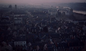 Movie still from “Le Grand Amour” (1969), directed by Pierre Étaix – An aerial view of a city at dusk; Extreme Wide shot, High angle