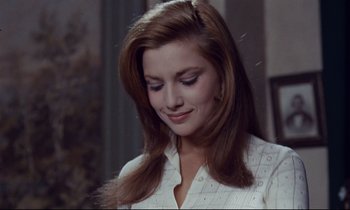 Movie still from “Le Grand Amour” (1969), directed by Pierre Étaix – A woman with long brown hair is looking down; Close Up shot, Over the shoulder angle