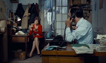 Movie still from “Le Grand Amour” (1969), directed by Pierre Étaix – A woman and a man sitting at a table; Wide shot, High angle