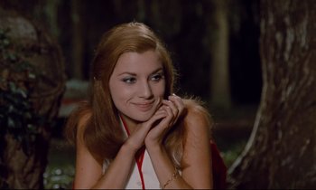 Movie still from “Le Grand Amour” (1969), directed by Pierre Étaix – A beautiful young lady posing for a picture; Medium shot, Low angle