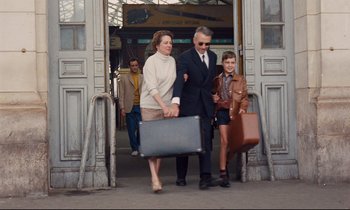 Movie still from “Le Grand Amour” (1969), directed by Pierre Étaix – An older man and a younger man carrying suitcases; Wide shot, Low angle