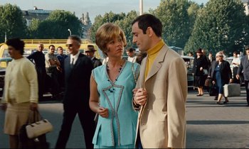 Movie still from “Le Grand Amour” (1969), directed by Pierre Étaix – A man and a woman standing next to each other on the street; Medium shot, Low angle