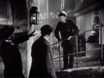 Movie still from “Le Plaisir” (1952), directed by Max Ophüls – A group of people standing next to a railing; Wide shot, Low angle