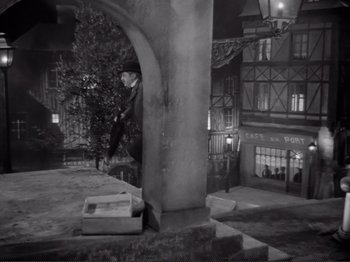 Movie still from “Le Plaisir” (1952), directed by Max Ophüls – A black - and - white photo of a street corner; Wide shot, High angle