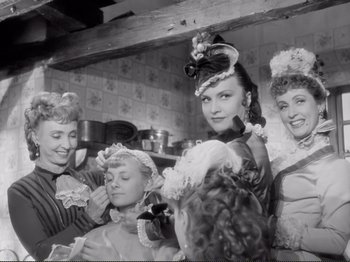 Movie still from “Le Plaisir” (1952), directed by Max Ophüls – A black and white photo of a group of women in a room; Medium shot, Low angle