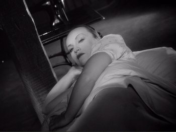 Movie still from “Le Plaisir” (1952), directed by Max Ophüls – A black and white photo of a woman laying on the ground; Close Up shot, High angle