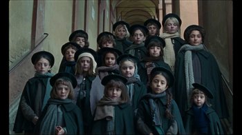 A group of young children wearing hats and scarfs