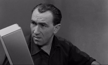 Movie still from “The Hole” (1960), directed by Jacques Becker – An older man looking at his reflection in a mirror; Close Up shot, High angle