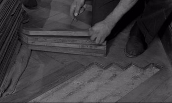 Movie still from “The Hole” (1960), directed by Jacques Becker – A man cutting a piece of wood with a pair of shears; Extreme Close Up shot, High angle