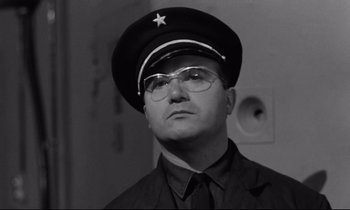 Movie still from “The Hole” (1960), directed by Jacques Becker – A man wearing a hat with a star on it; Close Up shot, Low angle