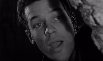 Movie still from “The Hole” (1960), directed by Jacques Becker – A person with ear phones on; Close Up shot, Low angle