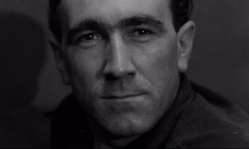 Movie still from “The Hole” (1960), directed by Jacques Becker – Black and white photograph of a man's face; Extreme Close Up shot, Low angle