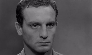 Movie still from “The Hole” (1960), directed by Jacques Becker – Black and white photograph of a man's face; Close Up shot, Low angle