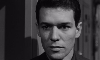 Movie still from “The Hole” (1960), directed by Jacques Becker – Black and white photograph of a young man's face; Close Up shot, Low angle