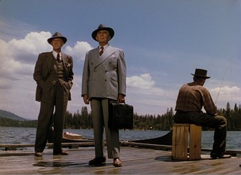 Movie still from “Leave Her to Heaven” (1945), directed by John M. Stahl – A group of men standing next to a body of water; Wide shot, Low angle