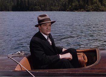 Movie still from “Leave Her to Heaven” (1945), directed by John M. Stahl – A man sitting in a boat on the water; Wide shot, High angle