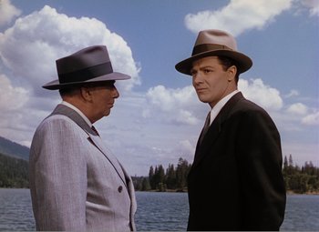 Movie still from “Leave Her to Heaven” (1945), directed by John M. Stahl – Two men standing next to a body of water; Medium shot, Low angle