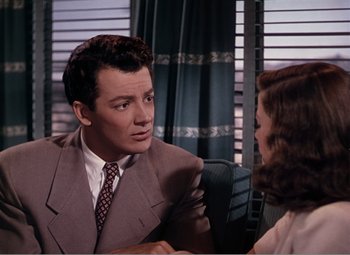 Movie still from “Leave Her to Heaven” (1945), directed by John M. Stahl – A man and a woman sitting at a table talking to each other; Medium shot, Over the shoulder angle