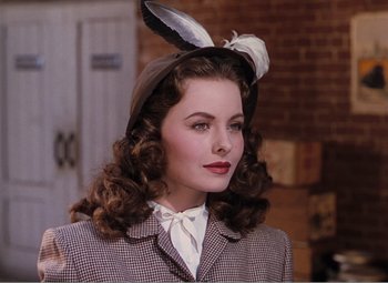 Movie still from “Leave Her to Heaven” (1945), directed by John M. Stahl – A woman with a bunny ear hat on; Close Up shot, Over the shoulder angle
