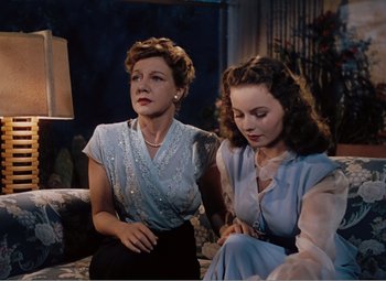 Movie still from “Leave Her to Heaven” (1945), directed by John M. Stahl – Two women sitting on a couch looking at each other; Medium shot, Low angle
