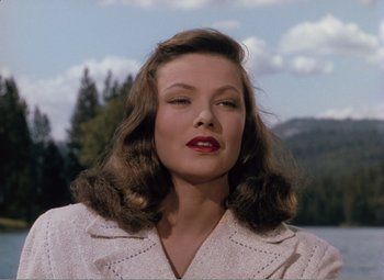 Movie still from “Leave Her to Heaven” (1945), directed by John M. Stahl – A beautiful woman with long brown hair wearing a white jacket; Close Up shot, Over the shoulder angle