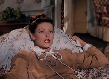 Movie still from “Leave Her to Heaven” (1945), directed by John M. Stahl – A beautiful woman laying on a bed in a room; Medium shot, Overhead angle