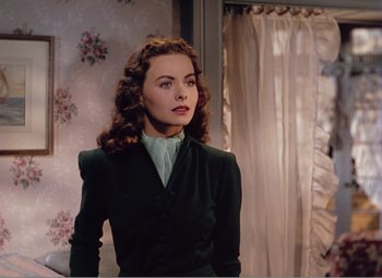 Movie still from “Leave Her to Heaven” (1945), directed by John M. Stahl – A woman with long hair wearing a green jacket; Medium shot, Over the shoulder angle